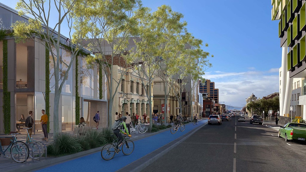 A street with cars and people on it.